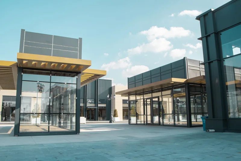 Clean glass shop fronts in an outdoor shopping center on a sunny day