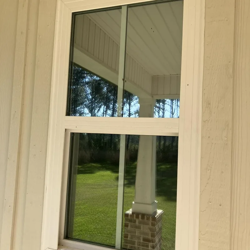 Home window with window film beside the porch — a job by RJ’s Tint Shop in Crestview, FL
