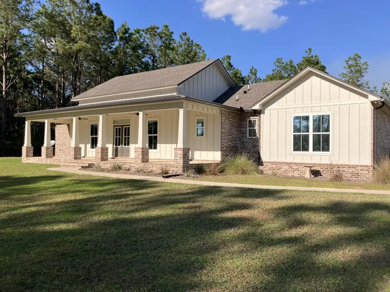 Farmhouse-style home with its windows filmed — a job by RJ’s Tint Shop in Crestview, FL