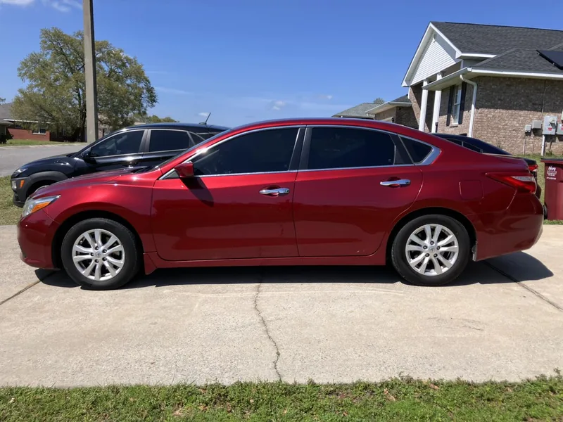 Red Nissan Altima with tinted side windows — a job by RJ’s Tint Shop in Crestview, FL
