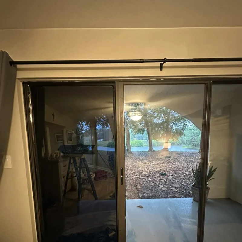 Sliding glass door with film on one pane beside a clear pane — a job by RJ’s Tint Shop in Crestview, FL