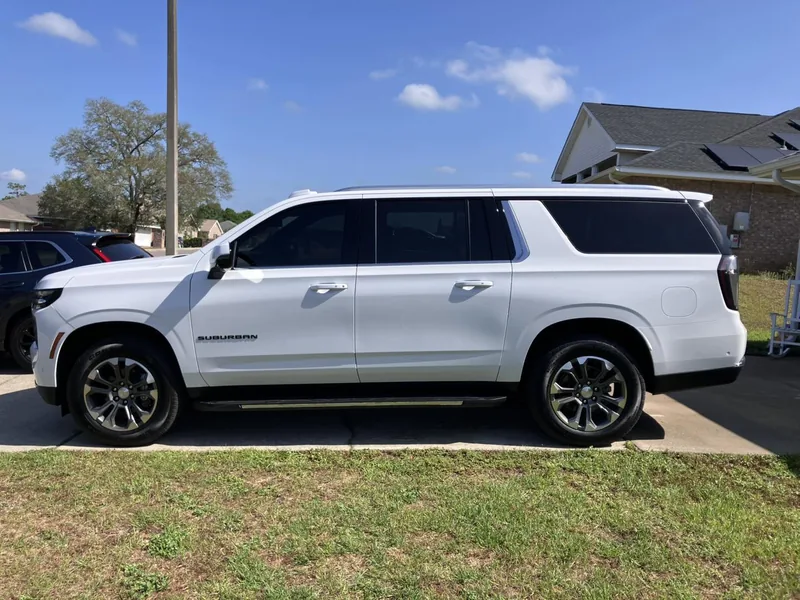 White Chevrolet Suburban with dark tinted side windows — a job by RJ’s Tint Shop in Crestview, FL
