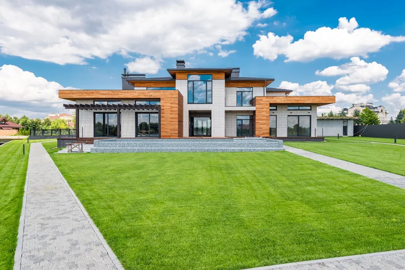 Modern house with big glass doors and windows on a sunny day